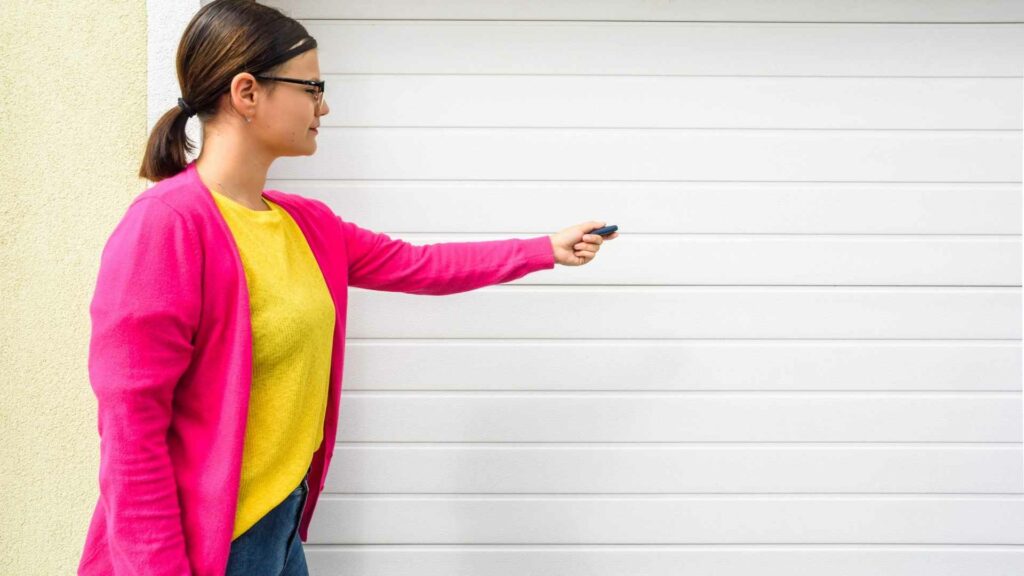 Women using remote to open garage