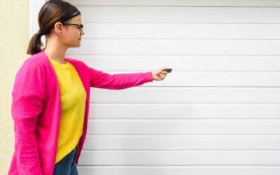 Women using remote to open garage