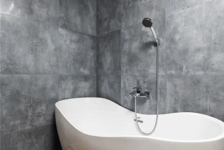 freestanding tub in grey tile